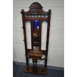 A VICTORIAN OAK HALL STAND, with six coat pegs surrounding a bevelled edge rectangular mirror, a