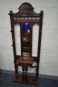 A VICTORIAN OAK HALL STAND, with six coat pegs surrounding a bevelled edge rectangular mirror, a