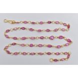 A YELLOW METAL, SAPPHIRE SPECTACLE SET NECKLACE, comprised of forty three mixed cut pink