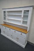 A LARGE PARTIALLY PAINTED AND PINE DRESSER, with an arrangement of shelves, cupboards and drawers,