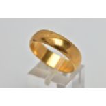 A YELLOW METAL WIDE BAND RING, plain polished wide band, approximate width 6.2mm, stamped '18ct',