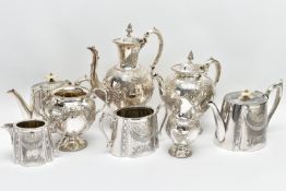 TWO WHITE METAL TEA SETS, the first comprising of a coffee pot, a tea pot, milk jug and sugar