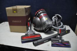 A DYSON BIG BALL TOTAL CLEAN2 along with a box of attachments (PAT pass and working)