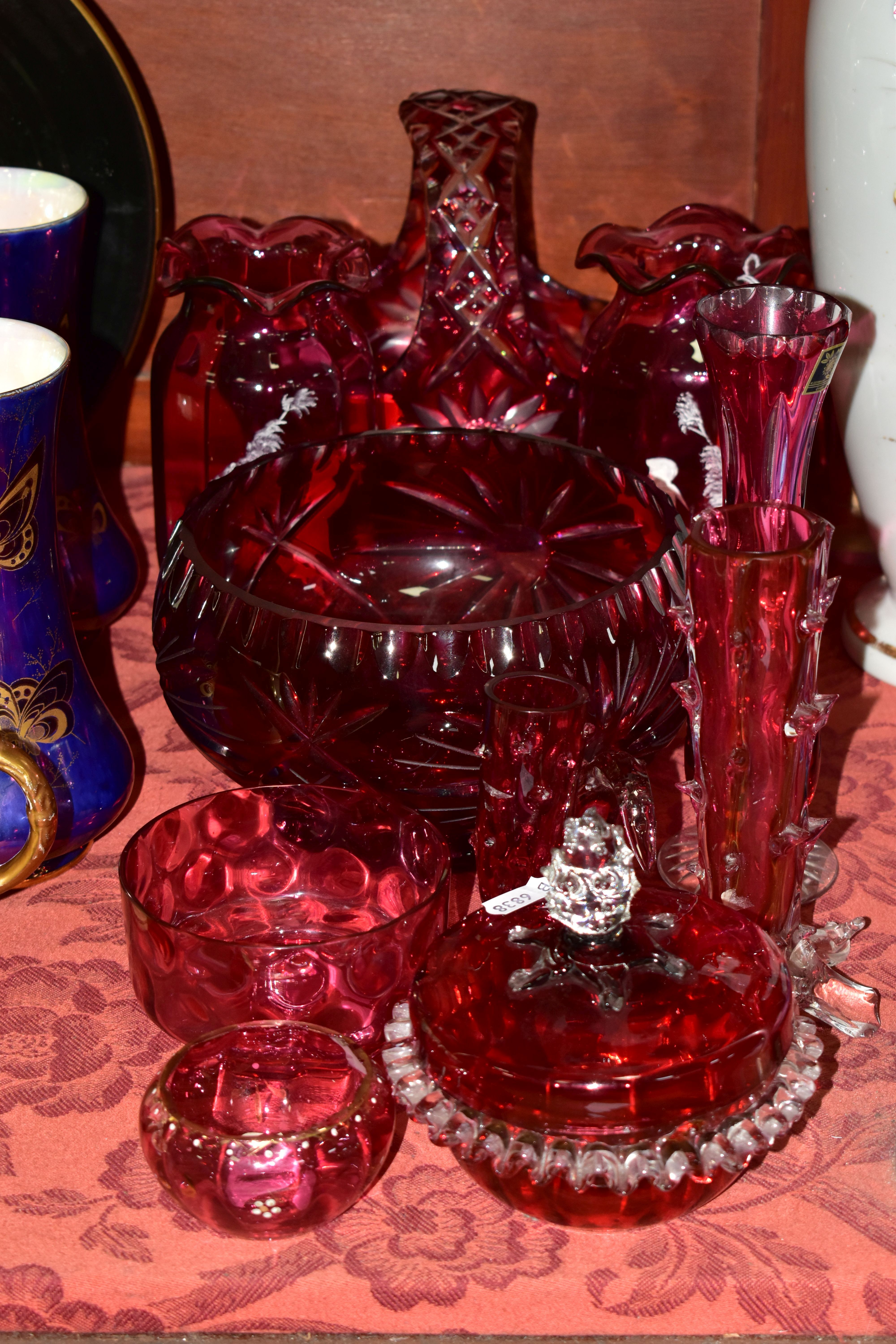 A GROUP OF CRANBERRY GLASS INCLUDING A PAIR OF MARY GREGORY STYLE VASES, with wavy rims, depicting a