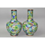 A PAIR OF 20TH CENTURY CHINESE CLOISONNE BALUSTER VASES, profusely decorated with flowers on a green