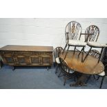 A 20TH CENTURY OAK CIRCULAR DROP LEAF TABLE, with trestle legs, united by a single stretcher,