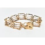 A 9CT GOLD GATE BRACELET, four bar polished yellow gold gate bracelet, fitted with a heart padlock