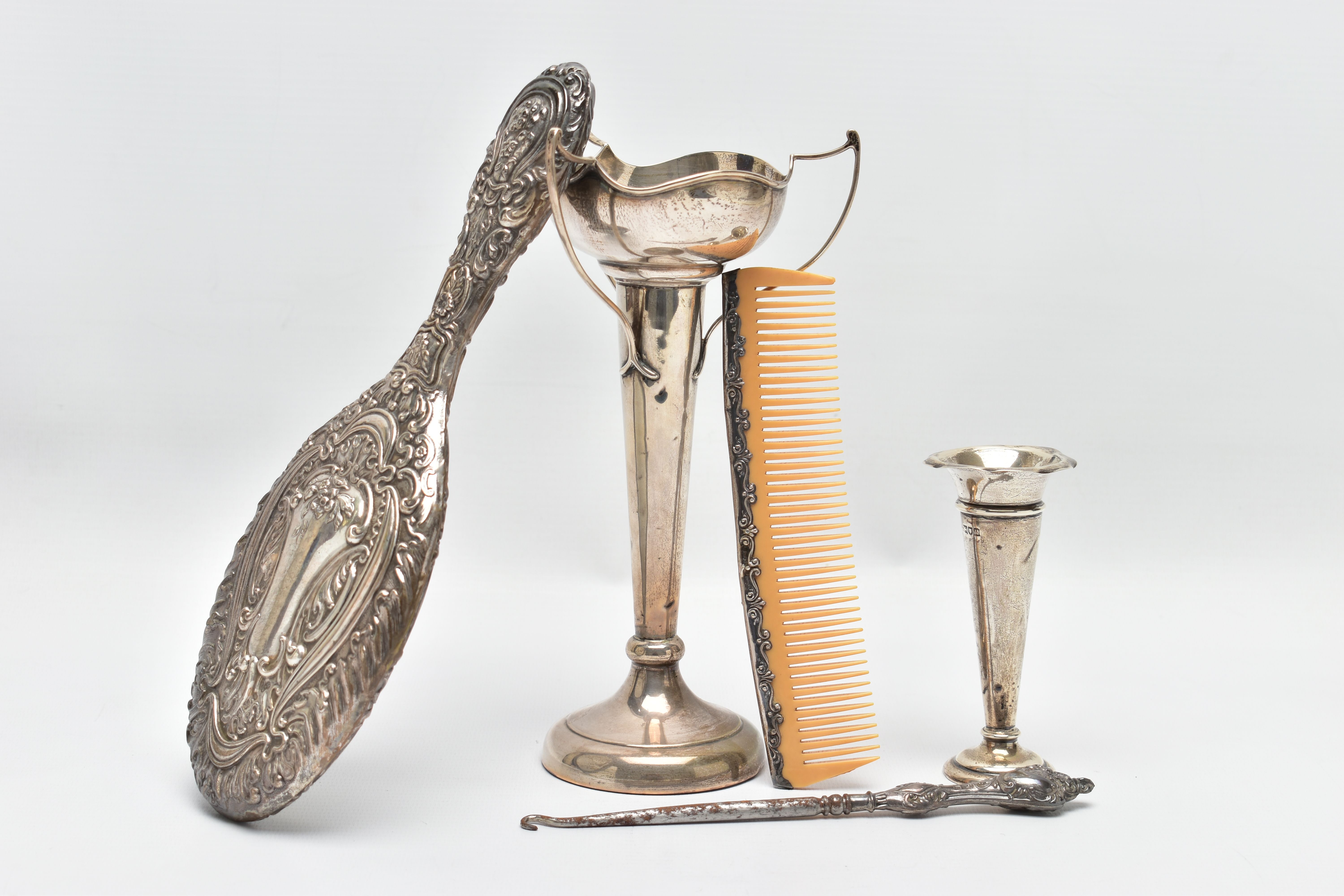 A SELECTION OF EARLY TO MID 20TH CENTURY SILVER, to include a scroll and floral embossed hand