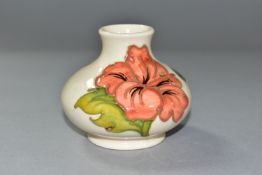 A SMALL MOORCROFT ORANGE HIBISCUS PATTERN VASE, of squat baluster form, foil label to the side,