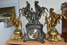 A FRENCH STYLE PEWTER CLOCK GARNITURE, the metal dial marked F.H.T with Arabic numerals, the case is