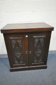 A 20TH CENTURY THAI ORIENTAL HEAVILY CARVED STAINED TEAK COCKTAIL CABINET, with a double fold over