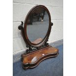 A VICTORIAN MAHOGANY OVAL DRESSING MIRROR, with foliate decoration, and hinged compartment, width