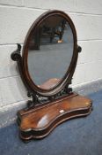 A VICTORIAN MAHOGANY OVAL DRESSING MIRROR, with foliate decoration, and hinged compartment, width