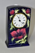 A MOORCROFT 'ANEMONE' PATTERN QUARTZ CLOCK, depicting flowers and foliage against a blue ground,