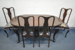 AN EARLY 20TH CENTURY MAHOGANY WIND OUT DINING TABLE, with rounded ends, one additional leaf, on