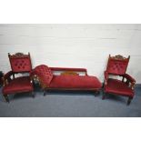 AN EDWARDIAN WALNUT SEVEN PIECE PARLOUR SUITE, covered with red upholstery, comprising a chaise