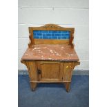 AN EDWARDIAN SATINWOOD WASHSTAND, with a tile back, marble top, and single door, width 83cm x