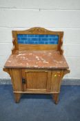 AN EDWARDIAN SATINWOOD WASHSTAND, with a tile back, marble top, and single door, width 83cm x