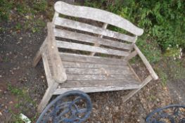 A VINTAGE HARDWOOD GARDEN BENCH with slatted seat and back, width 126cm
