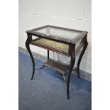 AN EDWARDIAN MAHOGANY BIJOUTERIE CABINET, on cabriole legs, united by a stretcher and undershelf,