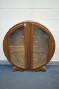 A 1930'S ART DECO DISPLAY CABINET, with geometric glazed doors, on two half round feet, width