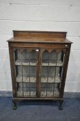 AN EARLY 20TH CENTURY MAHOGANY TWO DOOR CHINA CABINET, with two fixed shelves, on ball and claw