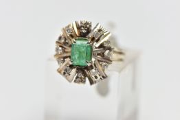 A 1970s EMERALD AND DIAMOND CLUSTER RING, of geometric design, set with a principal rectangular