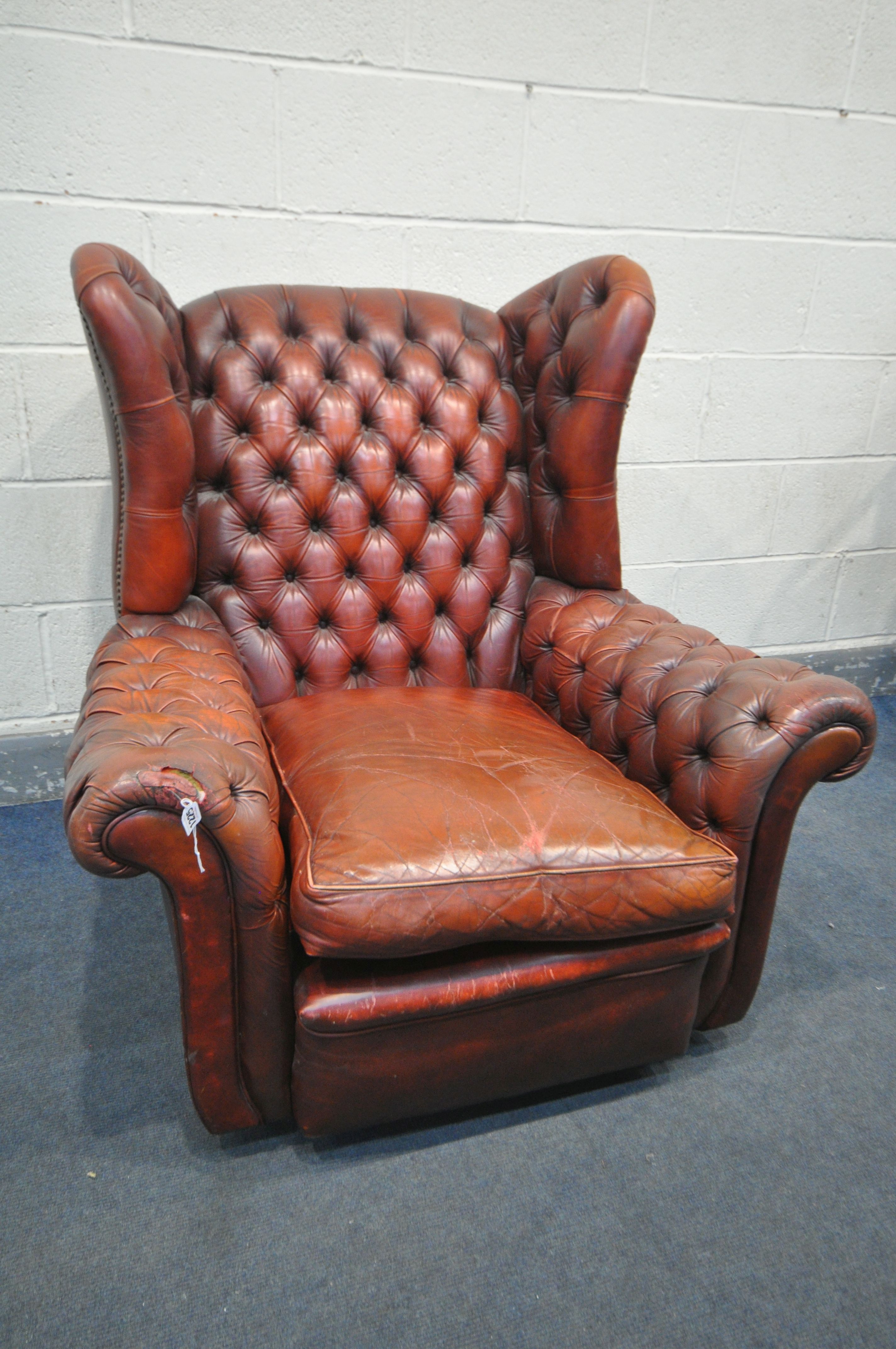 A BUTTONED OXBLOOD LEATHER ARMCHAIR, width 100cm x depth 106cm x height 104cm (condition:-torn
