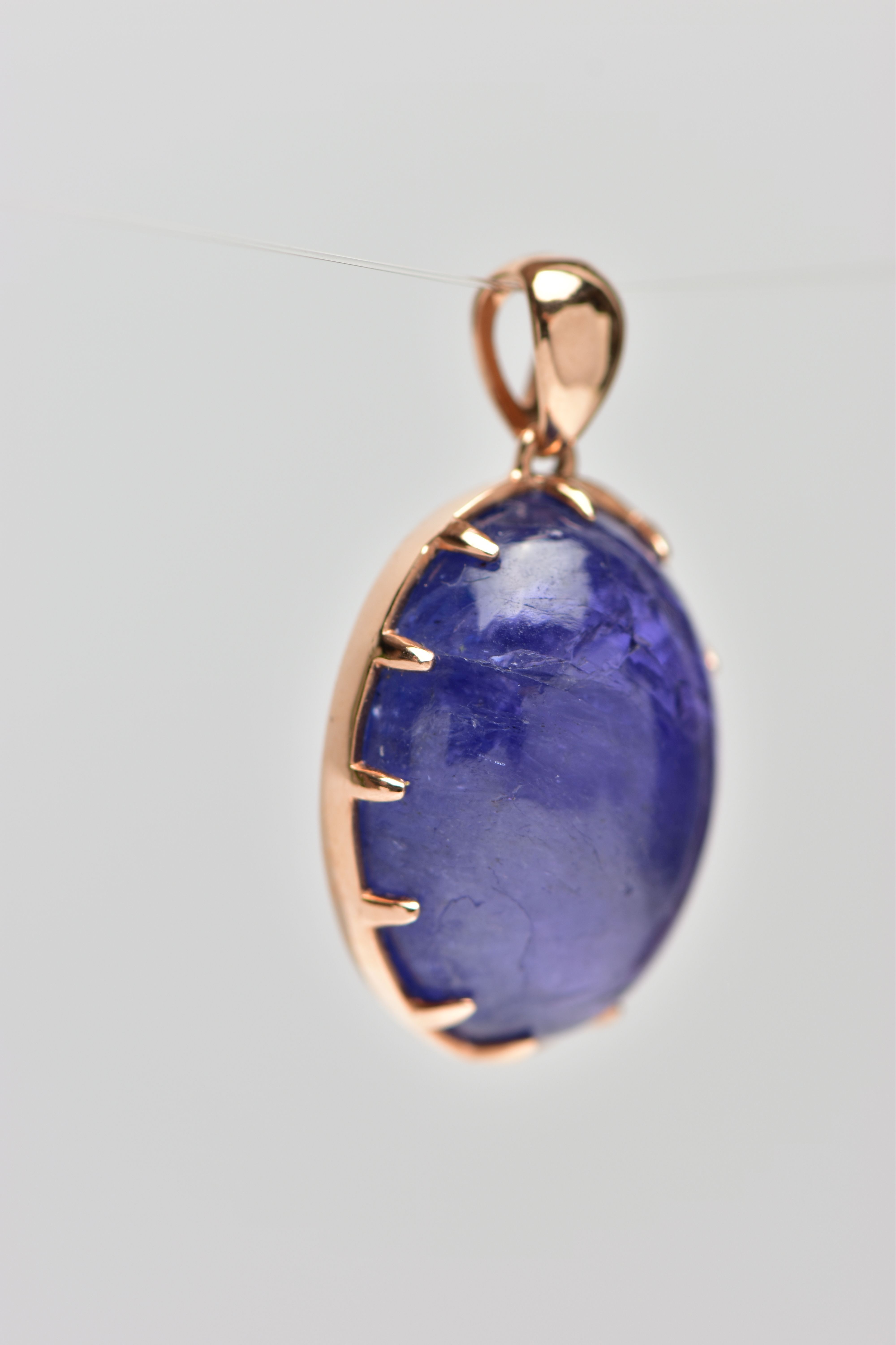 A TANZANITE CABOCHON PENDANT, comprising an oval tanzanite cabochon within a claw setting to the - Image 2 of 3