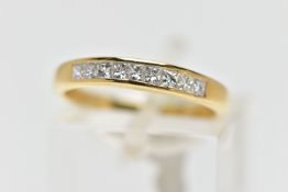 AN 18CT GOLD DIAMOND NINE STONE RING, channel set with graduated princess cut diamonds to the