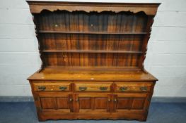 A GOOD QUALITY REPRODUCTION GEORGIAN STYLE OAK DRESSER, with a two tier plate rack, above a base