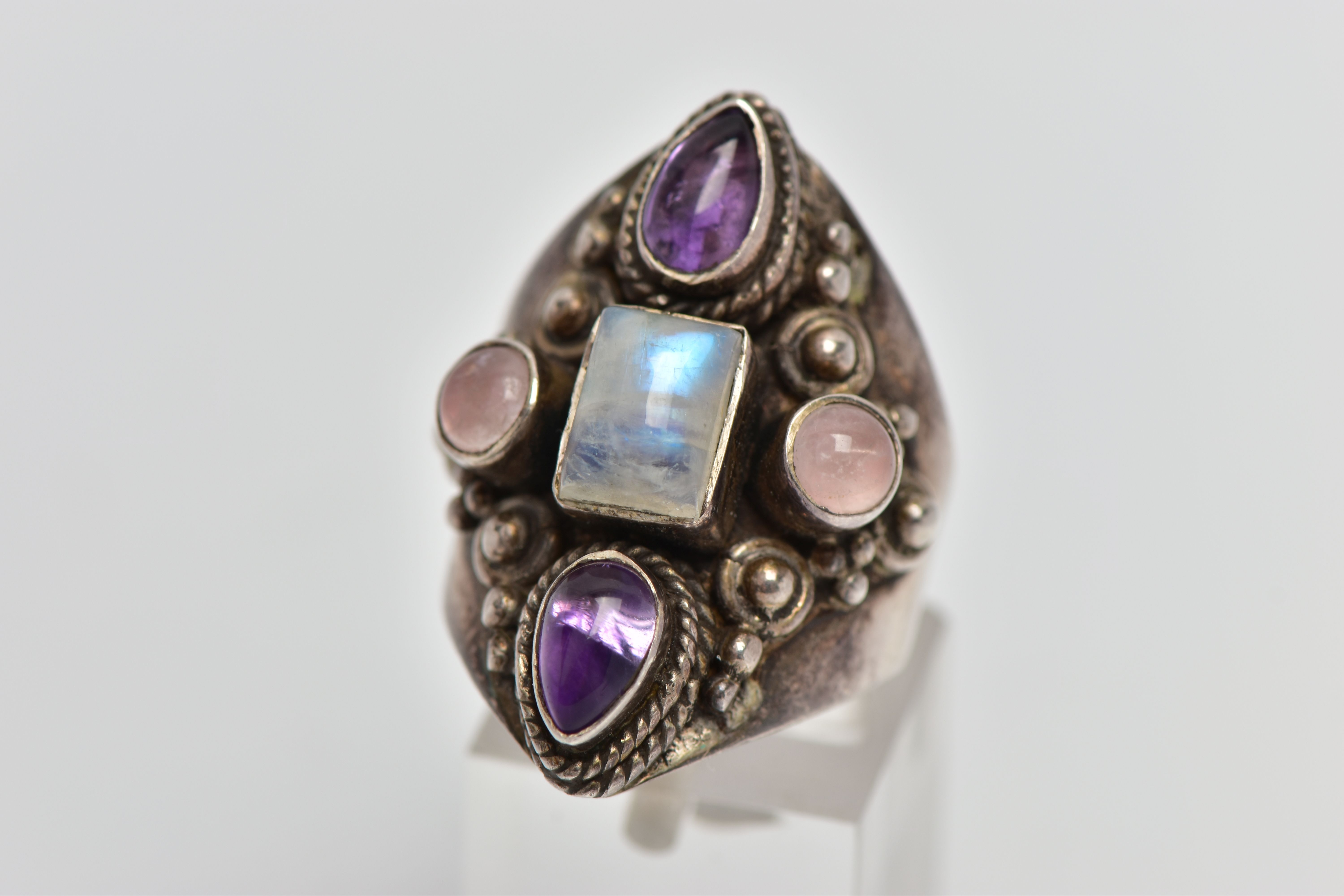 A GEM SET RING, a white metal dress ring, set with a cabochon moonstone centre stone, with
