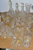 A GROUP OF CUT CRYSTAL AND OTHER GLASSWARES, comprising three decanters, a vase height 24.5cm, a