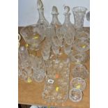 A GROUP OF CUT CRYSTAL AND OTHER GLASSWARES, comprising three decanters, a vase height 24.5cm, a