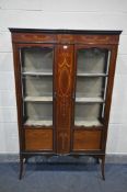 AN EDWARDIAN MAHOGANY AND MARQUETRY TWO DOOR DISPLAY CABINET, with two fixed shelves, on splayed