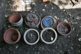 A SELECTION OF TERRACOTTA AND GLAZED PLANT POTS, of various sizes and shapes, largest plant pot size