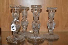 TWO PAIRS OF WATERFORD CRYSTAL CUT GLASS CANDLESTICKS, both pairs with baluster stems and domed