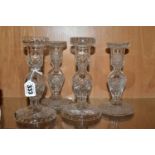 TWO PAIRS OF WATERFORD CRYSTAL CUT GLASS CANDLESTICKS, both pairs with baluster stems and domed