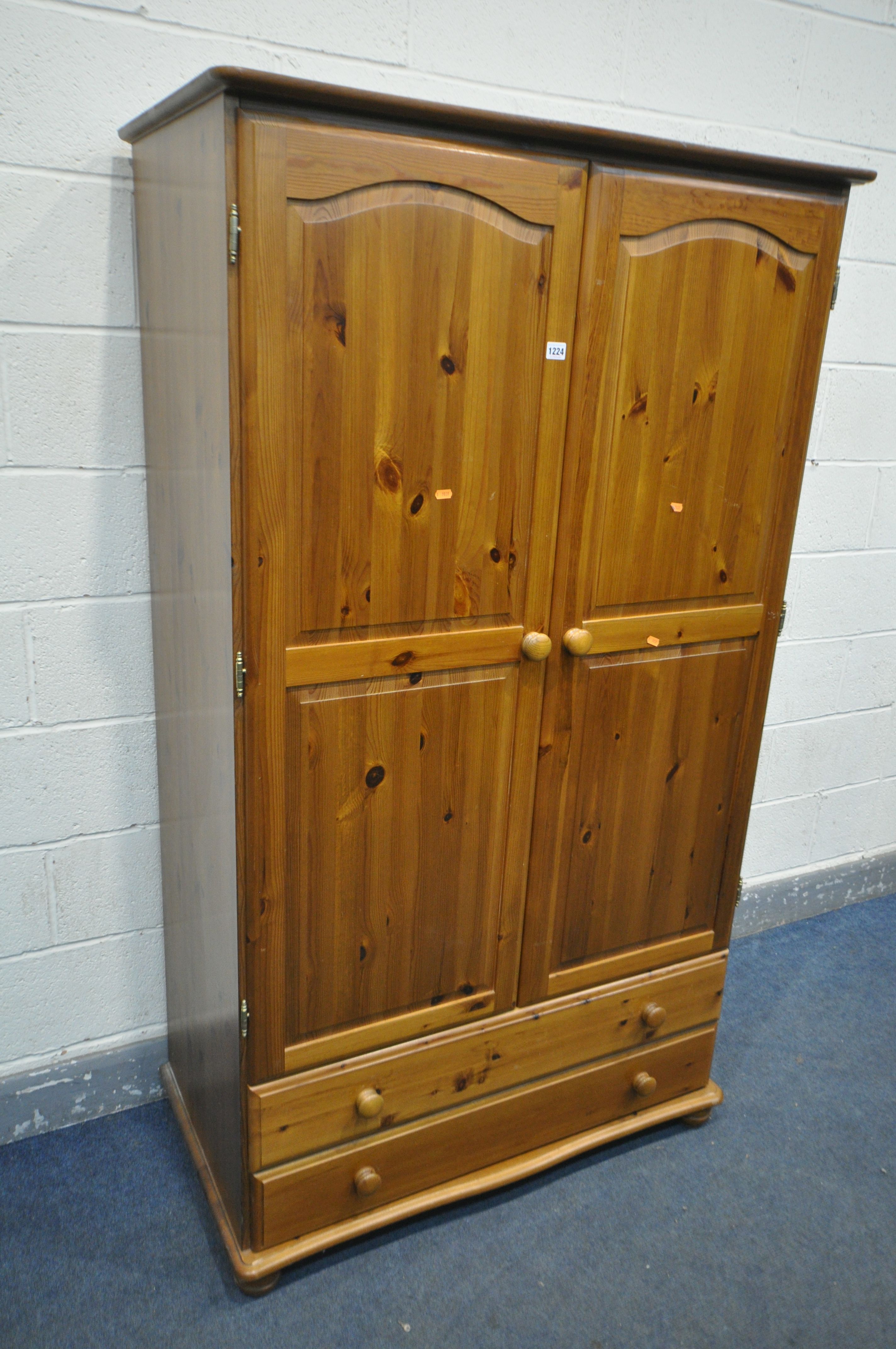 A MODERN PINE DOUBLE DOOR WARDROBE, with two drawers, width 104cm x depth 56cm x height 182cm