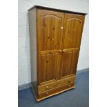 A MODERN PINE DOUBLE DOOR WARDROBE, with two drawers, width 104cm x depth 56cm x height 182cm