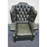 A GREEN LEATHER BUTTONED CHESTERFIELD ARMCHAIR, on front cabriole legs, width 83cm x depth 88cm x