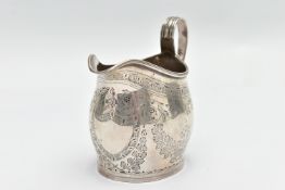 AN EARLY 20TH CENTURY SILVER MILK JUG, with vacant cartouche shield, to the floral and foliate