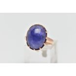 A TANZANITE CABOCHON RING, comprising an oval tanzanite cabochon within a claw setting to the