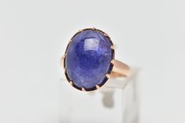 A TANZANITE CABOCHON RING, comprising an oval tanzanite cabochon within a claw setting to the