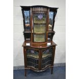 AN ARTS AND CRAFTS MAHOGANY AND MARQUETRY INLAID SERPENTINE DISPLAY CABINET, the top with beveled