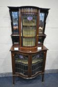 AN ARTS AND CRAFTS MAHOGANY AND MARQUETRY INLAID SERPENTINE DISPLAY CABINET, the top with beveled