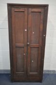AN EARLY 20TH CENTURY STAINED PINE TWO DOOR CUPBOARD, enclosing five shelves, width 93cm x depth