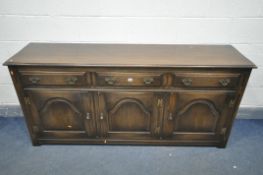 A REPRODUX OAK SIDEBOARD, with three drawers above fielded panel cupboard doors, width 183cm x depth