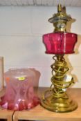 AN EARLY 20TH CENTURY BRASS BASED OIL LAMP CONVERTED TO ELECTRICTY, acid etched opaque cranberry