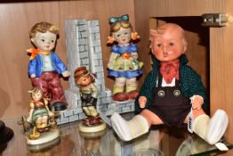 A PLASTIC GOEBEL HUMMEL BOY DOLL, TWO HUMMEL FIGURES AND A PAIR OF HUMMEL STYLE BOOKENDS, the doll